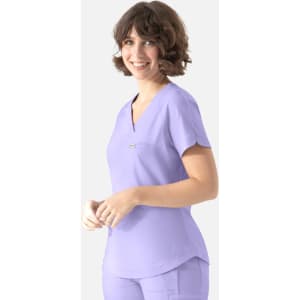 A light purple tuckable Y-neck top with short sleeves, featuring a pocket and a branding logo.
