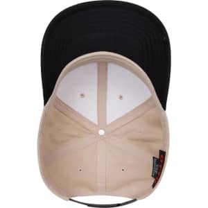 A beige and black 6 panel mid profile baseball cap featuring a structured crown and a curved peak.