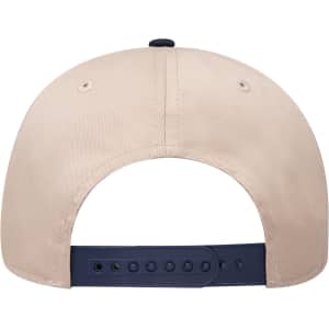 A beige 6 panel mid-profile baseball cap with a navy adjustable strap at the back and a logo on the side.