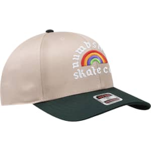 A beige mid-profile baseball cap with a green peak and a logo featuring a rainbow design.