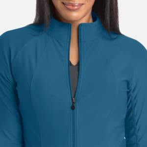 A full zip track jacket in teal, featuring a zip closure and a sleek, fitted design with branding.