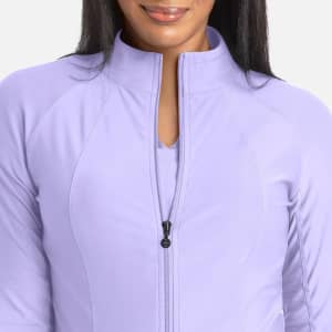 A full zip track jacket in a soft lavender colour with a high collar and a sleek design. It features a logo.