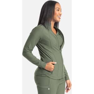A full zip track jacket in olive green, featuring a sleek design and a logo. The model is smiling while posing.
