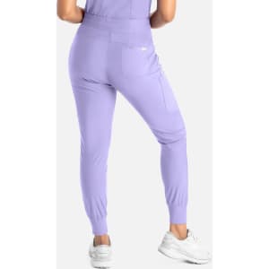 A pair of mid-rise joggers in lilac, featuring a back pocket and ribbed cuffs, paired with white sneakers.