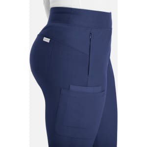 A side view of mid-rise joggers in navy blue, featuring pockets and a branded logo.