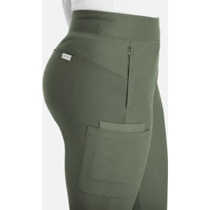 A close-up of green mid-rise joggers featuring side pockets and a small logo.