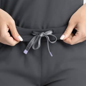 A mid-rise jogger in charcoal grey featuring a drawstring waistband. The jogger includes a logo on the drawstring.
