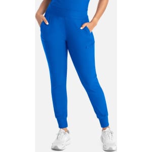 Bright blue mid-rise joggers with pockets, styled with a fitted top and white sneakers.