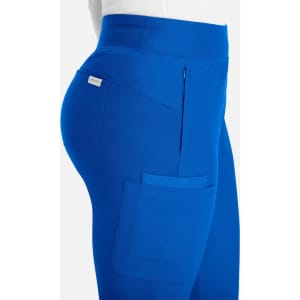 A side view of bright blue mid-rise jogger pants featuring a side pocket and branding.