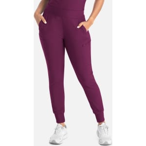 Mid-rise joggers in a rich plum colour with side pockets and a tapered leg design. Features a logo on the waistband.
