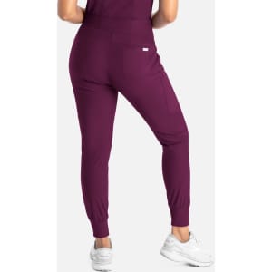 A pair of mid-rise joggers in a rich purple colour, featuring a fitted ankle and side pockets.