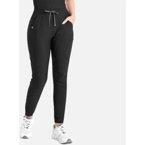 Tapered leg pants in black with an elasticated waistband and side pockets, worn with white sneakers.