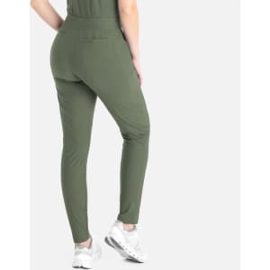 A woman wearing olive green tapered leg pants from the back, featuring a pocket and paired with white sneakers.