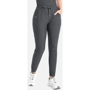 A pair of grey tapered leg pants with an elastic waistband and pockets, featuring a branding logo.