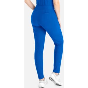 A pair of blue tapered leg pants with a fitted design, featuring pockets and an elastic waistband, displayed from the back.