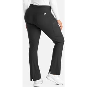A pair of black bootcut pants with a fitted waistband and side slits at the hem, featuring a logo on the back.