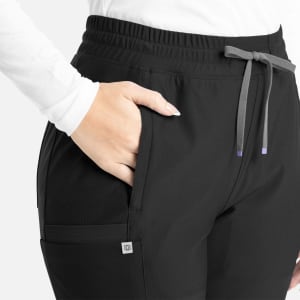 A black bootcut pant with an elastic waistband and pockets, featuring a subtle logo on the side.