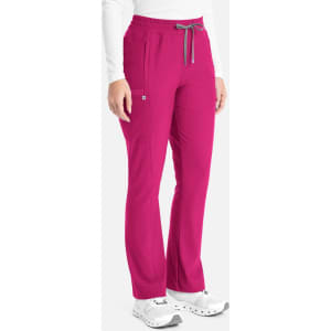 A pair of bootcut pants in vibrant fuchsia, featuring an elastic waistband and a logo on the side.