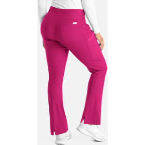A pair of pink bootcut pants with a slight flare at the bottom and a back pocket, featuring a logo.