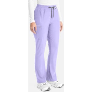 A pair of lilac bootcut pants with a drawstring waist and two side pockets. The pants feature a logo on the side.