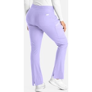 A pair of lilac bootcut pants with a pocket and side slits, viewed from the back. Features a branding logo.
