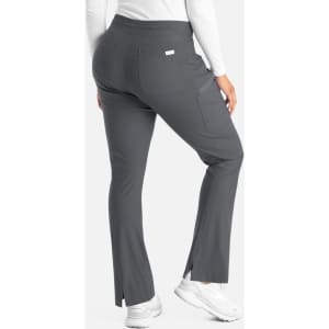 A pair of grey bootcut pants with a back pocket and subtle side slits, featuring a logo tag.
