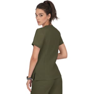 A woman wearing an olive green top, facing away from the camera, with a ponytail hairstyle. The top has short sleeves.
