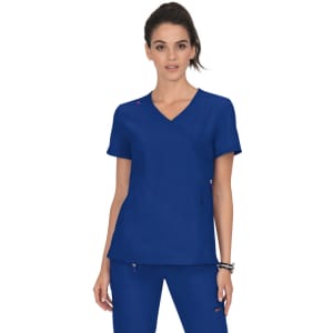 A woman wearing a vibrant blue medical scrub top with a stylish design and a small logo.