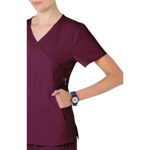 A burgundy scrub top with a V-neck design and a visible side pocket, worn with a wristwatch.
