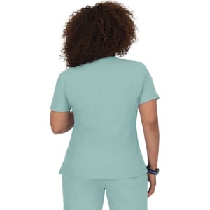 A short-sleeved scrub top in light teal, featuring a simple design and back view. It includes a logo.