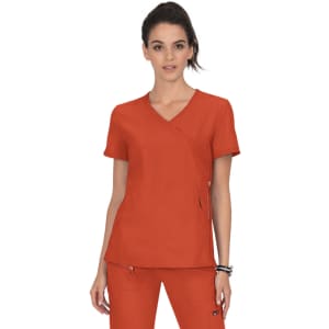 A medical scrub top in a vibrant orange colour, featuring a wrap-style design and a logo on the side.