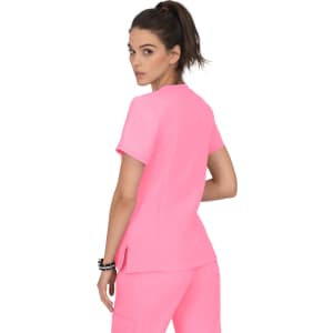A bright pink top with a simple design, featuring short sleeves and a slight side split.