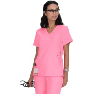 A pink medical top with a V-neck design and a zipper pocket, worn by a model holding glasses. It features a logo.