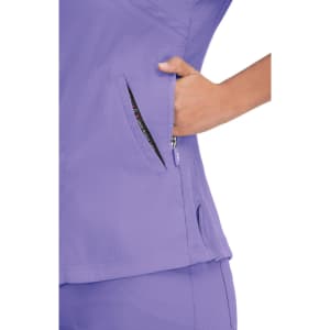 A purple top with a zipped pocket, featuring a textured fabric and a side vent for added comfort.