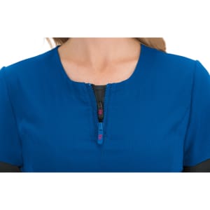 A blue top featuring a half-zip design, with a smooth texture and a round neckline. It has a logo on the zipper.
