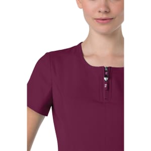 A burgundy top with a short zipper and a round neckline, featuring short sleeves. It includes a logo on the zipper.