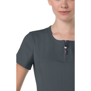 A close-up of a grey top featuring a zippered neck and short sleeves, with a logo on the zipper pull.