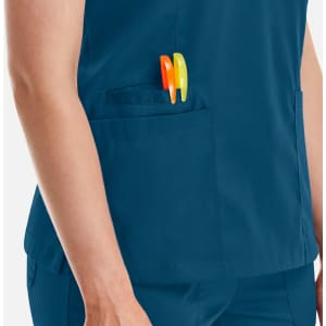A blue women's double V-neck top with a pocket holding orange and yellow pens.