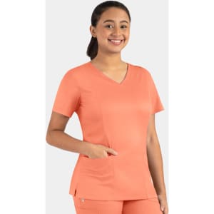 A model wears a coral Matrix Women's Double V-Neck Top with a pocket, featuring a logo on the side.