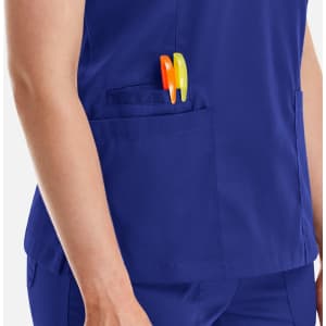 A deep blue women's top featuring a pocket with orange and yellow pens.