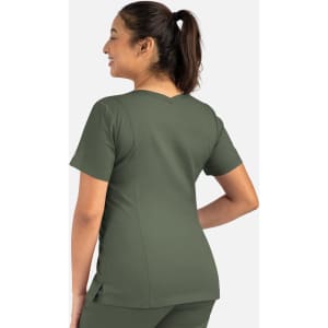 A woman wearing an olive green double V-neck top, showcasing the back design of the garment.