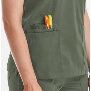 A green Matrix Women's Double V-Neck Top featuring two pens in the side pocket.