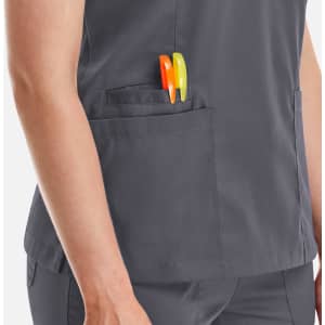 A women's double V-neck top in grey with two pens in the side pocket. It features a logo on the fabric.