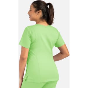 A woman is wearing a light green double V-neck top, showcasing a relaxed fit and short sleeves.