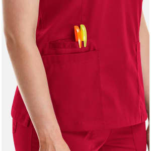 A close-up of a red women's top featuring a side pocket with orange and green pens.