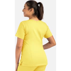 A woman in a bright yellow double V-neck top, showcased from the back, with a ponytail hairstyle.