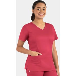 A woman wearing a vibrant raspberry-coloured double V-neck top with a pocket, featuring a branding logo.