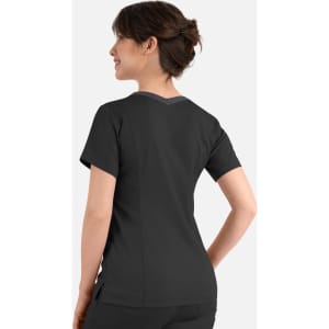 A woman wearing a black Matrix Women's Contrast Double V-Neck Top, showing a clean back design with subtle detailing.