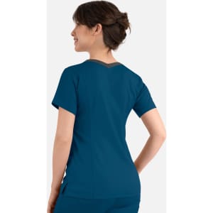 A women's double V-neck top in teal, featuring short sleeves and a contrasting neckline, with a logo on the back.