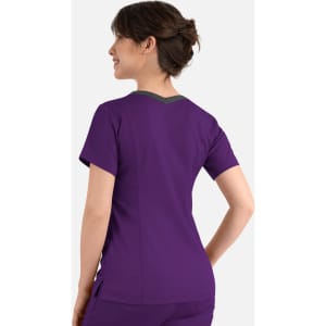 A women's double V-neck top in purple with a contrasting grey neckline and a logo on the back.